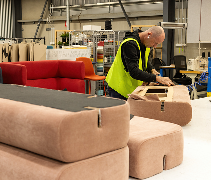 Worker manufacturing a couch panel