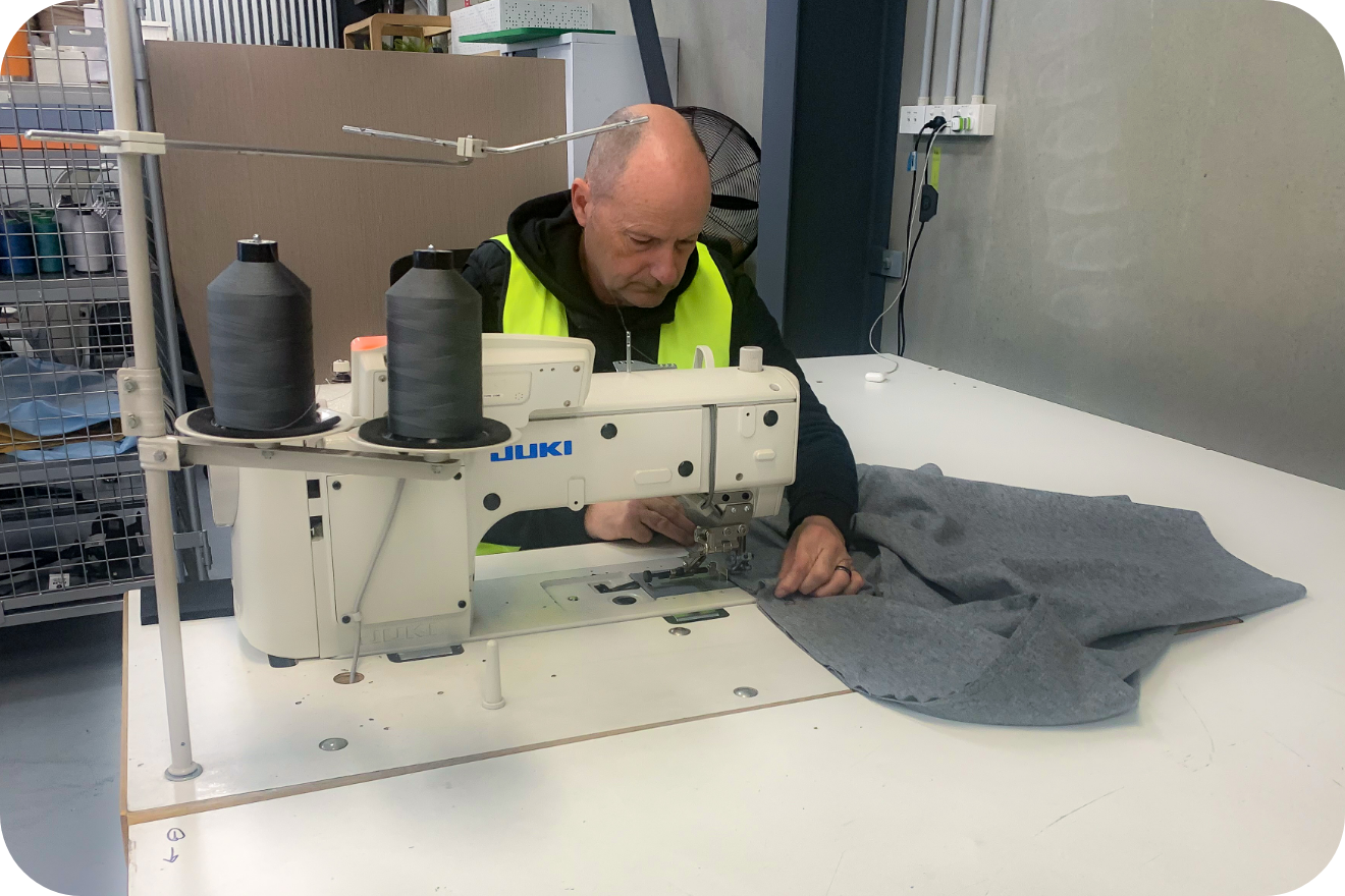 Person operating industrial sewing machine