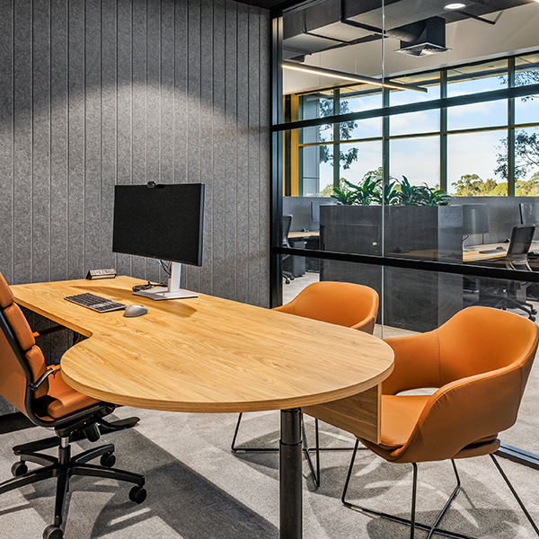 Modern office with orange chairs and desk